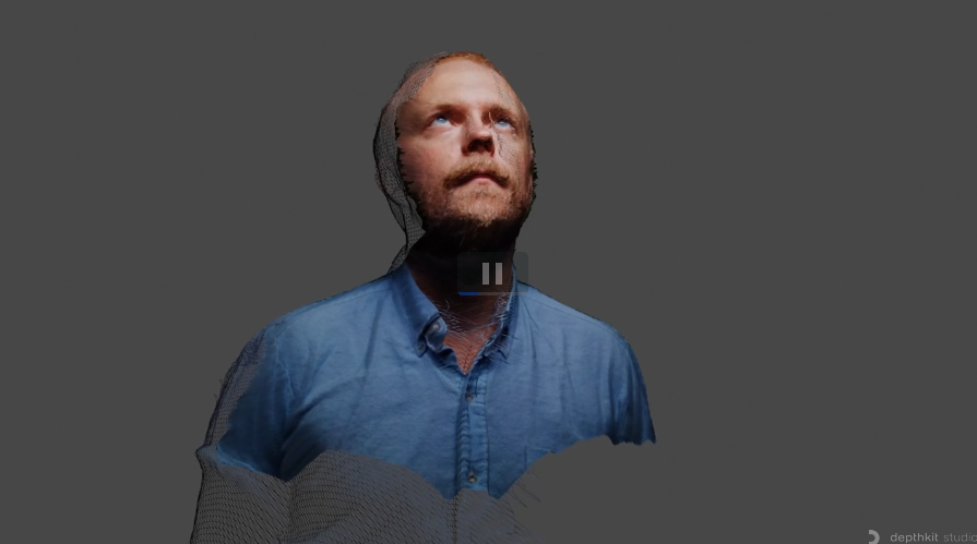 A clean reconstructed volumetric portrait of a person in a blue shirt floats against a neutral gray field.