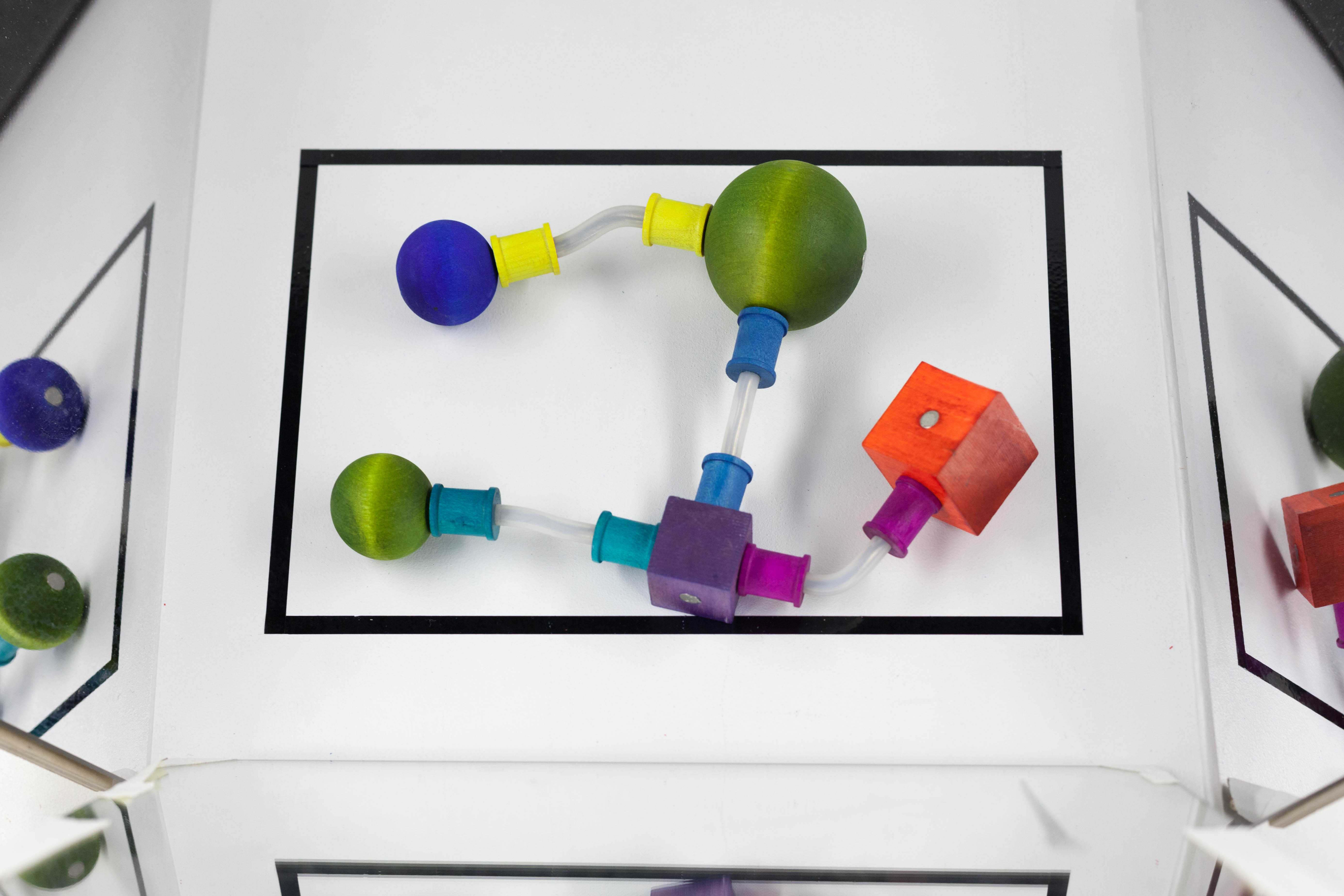 A 'curio' made of colored wood blocks sits inside a black rectangle.