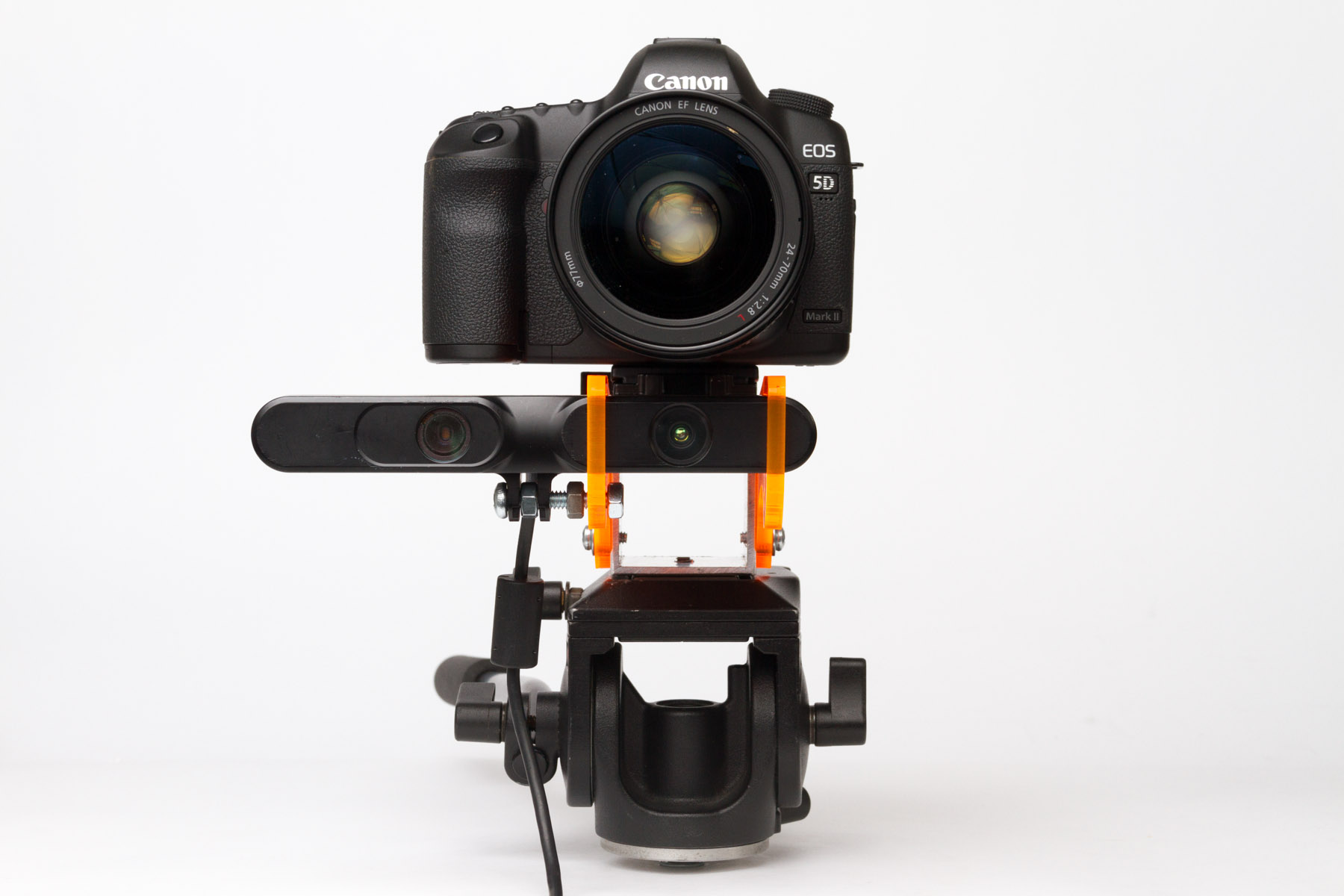 Front view of a DSLR and depth sensor aligned vertically on an orange Depthkit camera mount.