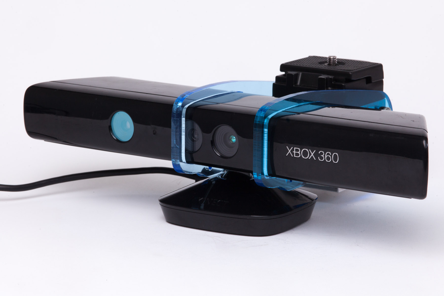 Oblique view of a Kinect sensor secured to a blue transparent Depthkit camera mount.