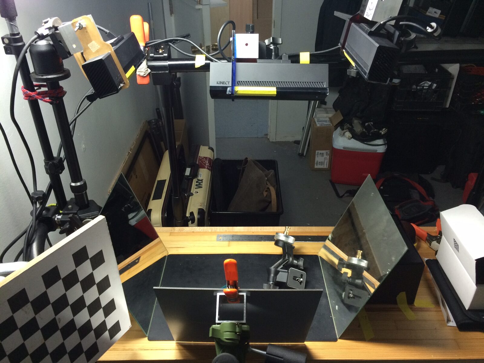Multiple Kinect sensors and mirrors are arranged inside the Curio Aquarium cabinet during spatial-capture calibration.