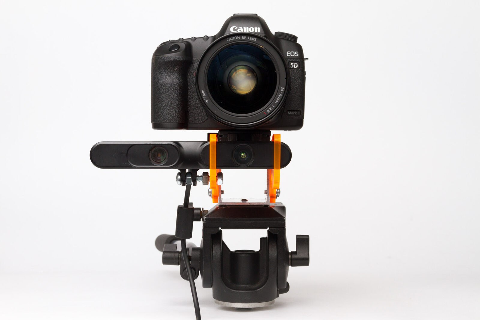 Front view of a DSLR and depth sensor aligned vertically on an orange Depthkit camera mount.