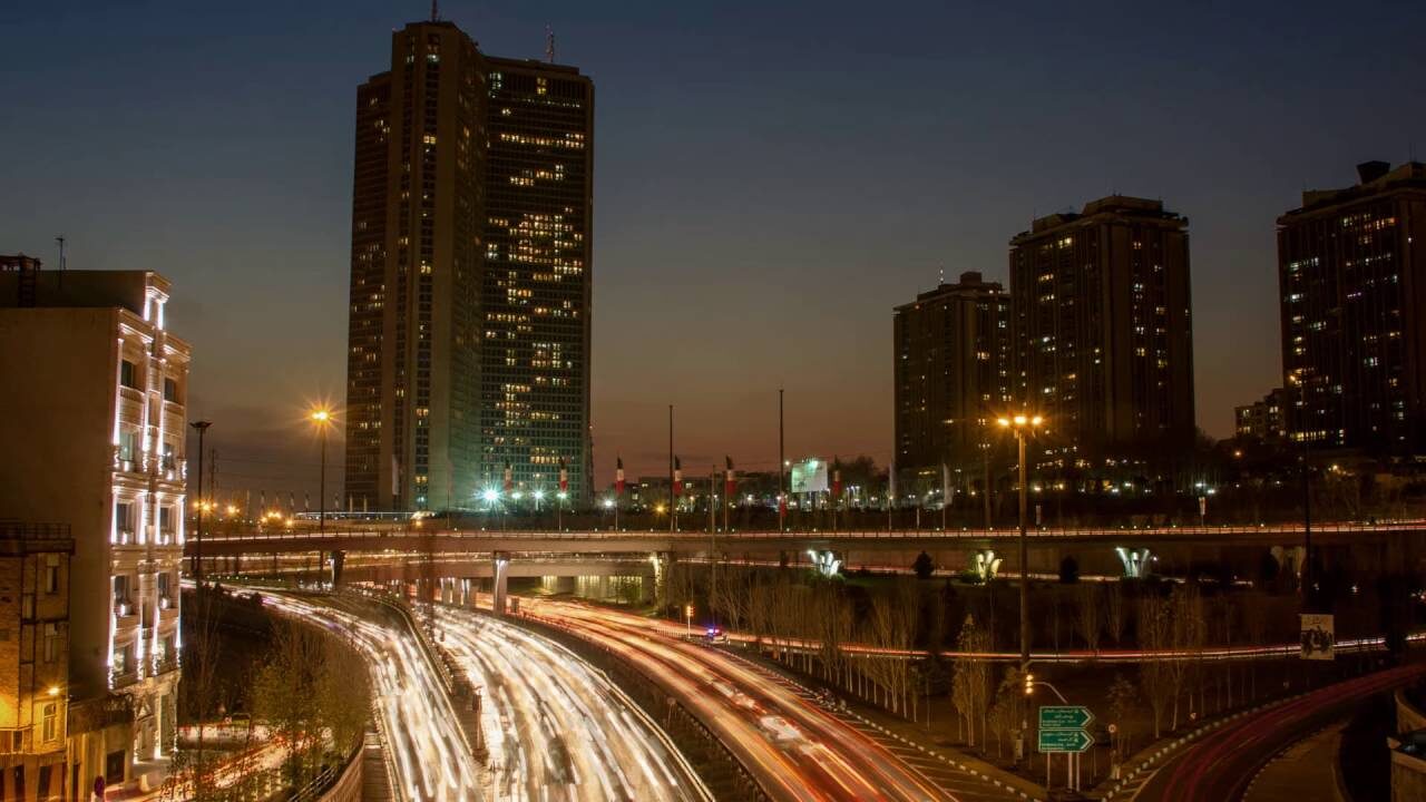 City towers and curving traffic light trails at dusk from the official Zero Days trailer.